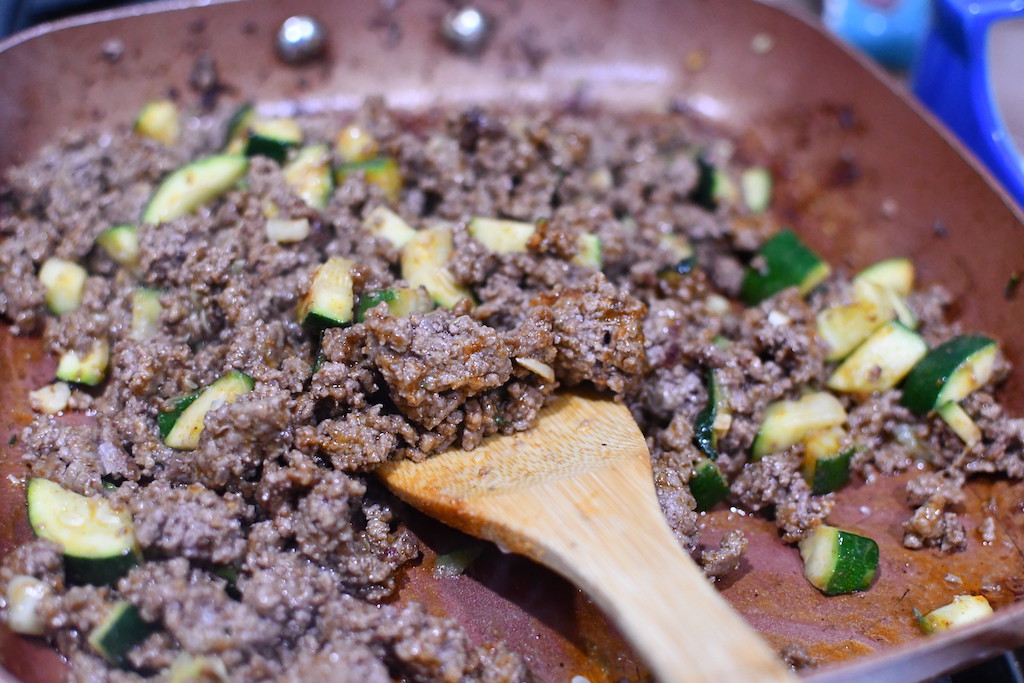 ground beef and zucchini in frying pan 
