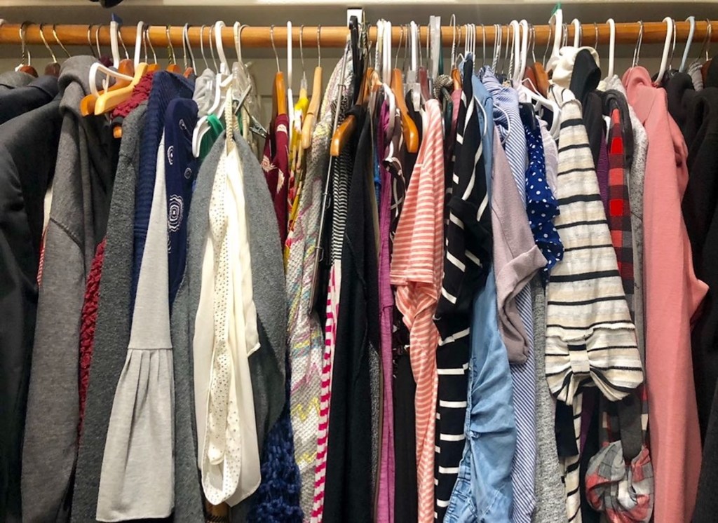 clothes closet with various colored clothing hanging up