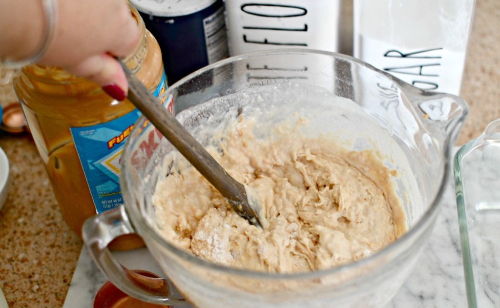 mixing up peanut butter bread in a mixing bowl