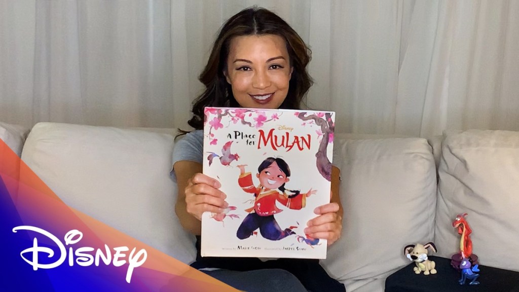 actress holding up Mulan picture book
