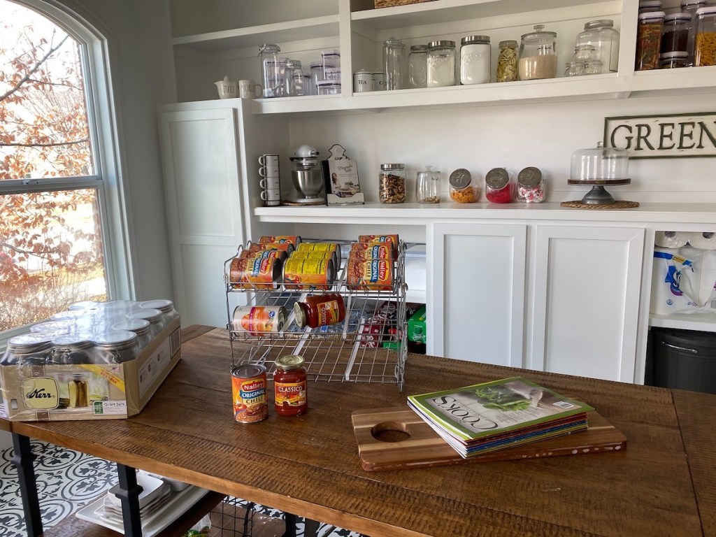 can organizer sitting on wood table in huge pantry room