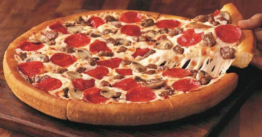 picture of meat pizza from pizza hut with slice being pulled out