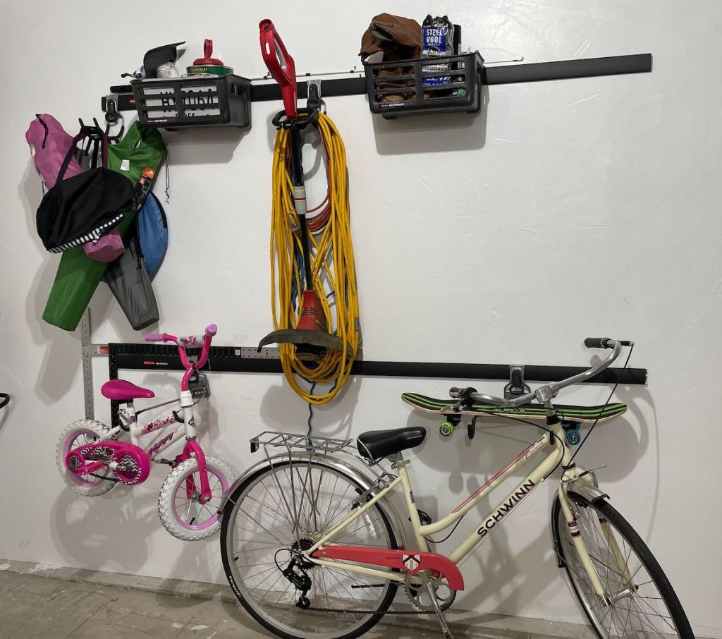 garage organization system on wall with tools and bikes