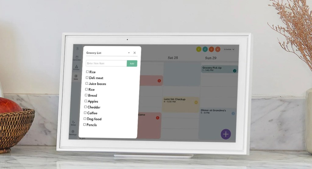 close up of skylight digital calendar on countertop with grocery list