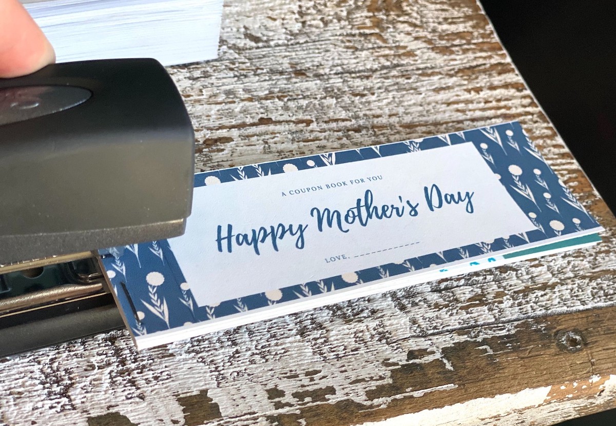 stapler putting together coupon book for mom
