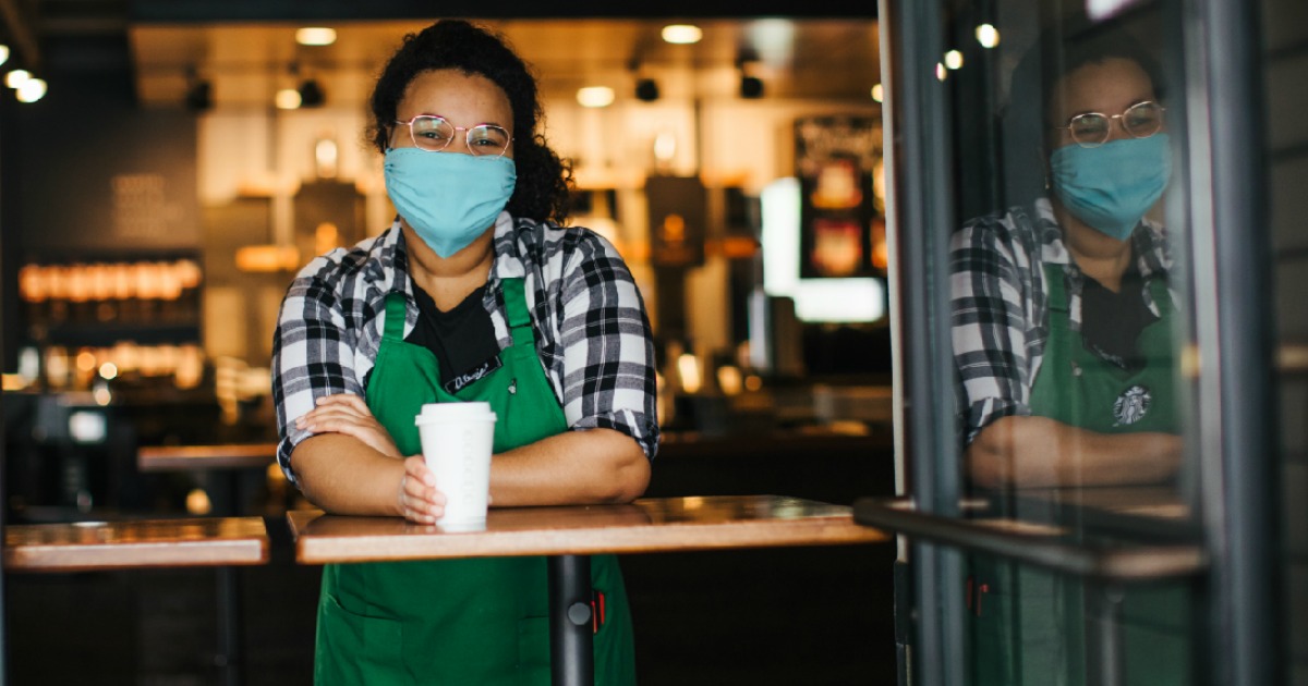 barista wearing health mask standing at counter