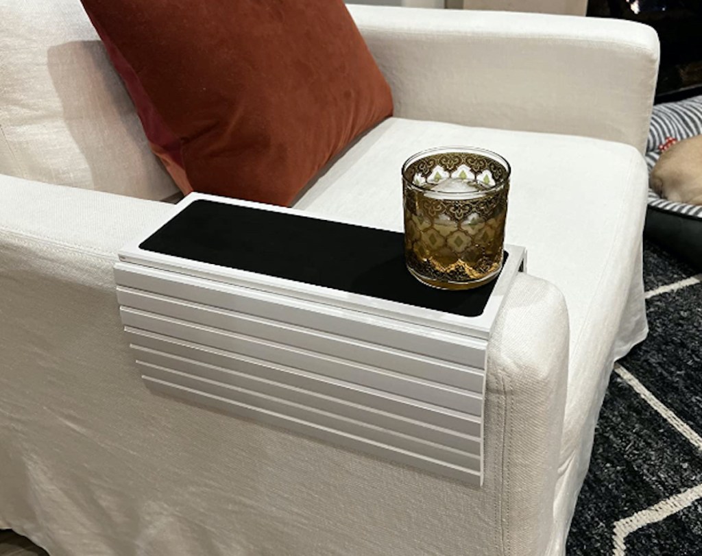 white bendable tray on chair with glass cup