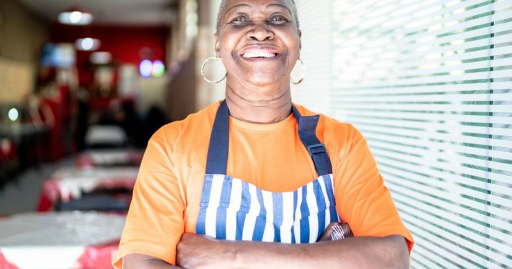 restaurant owner with apron on smiling 