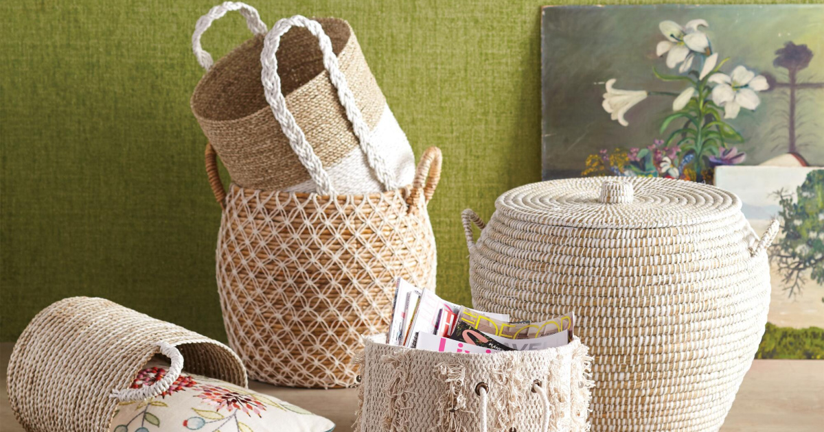 different wicker baskets together with green wall and flower painting in background