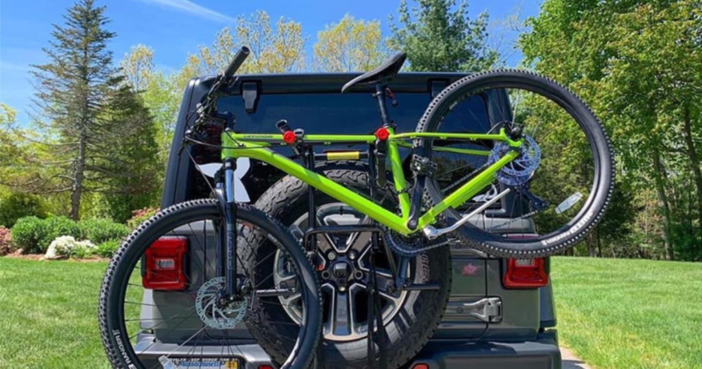 green back on tire bike rack on car