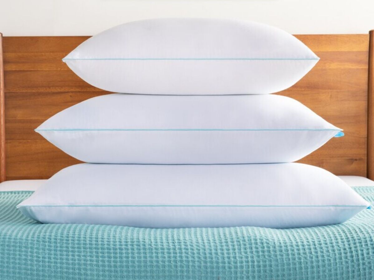three pillows on bed stacked up 