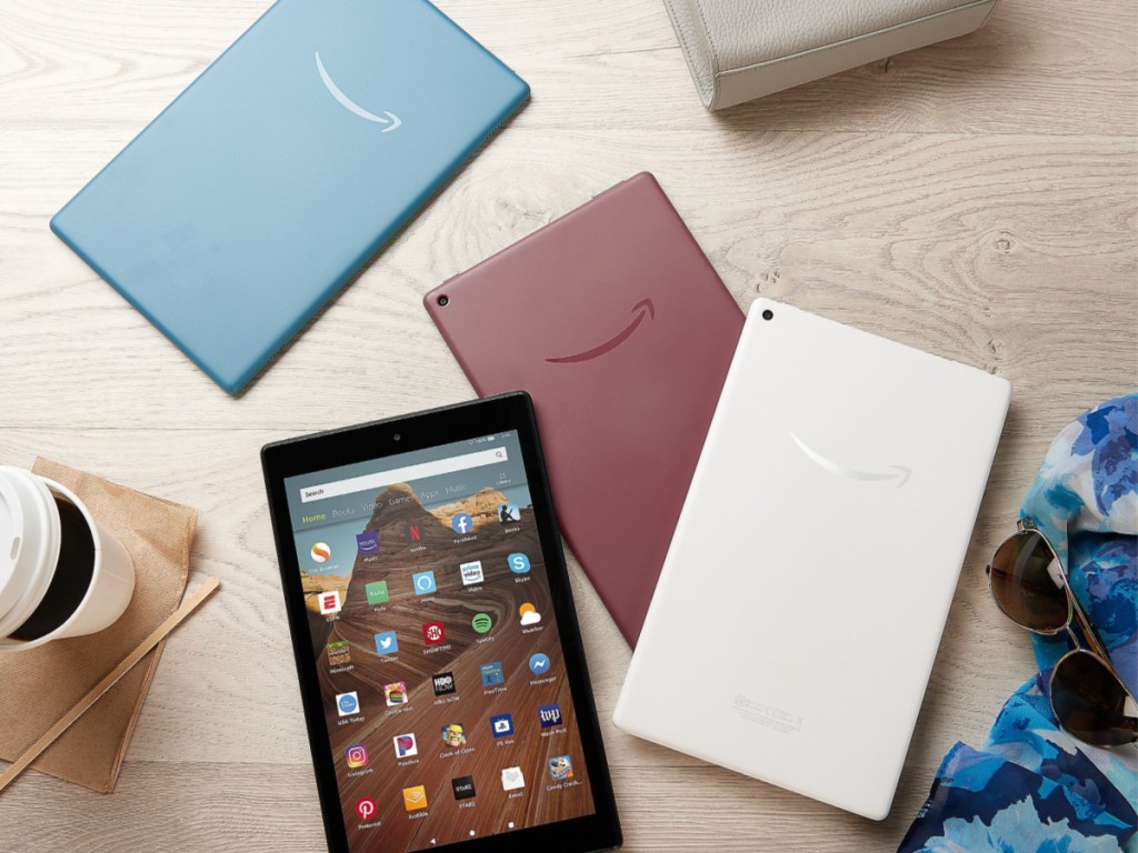 black tablet, white tablet, maroon tablet, and blue tablet on table