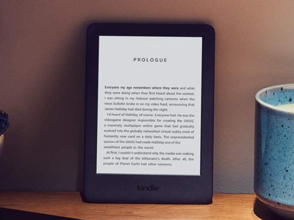 black e-reader leaning on wall and desk