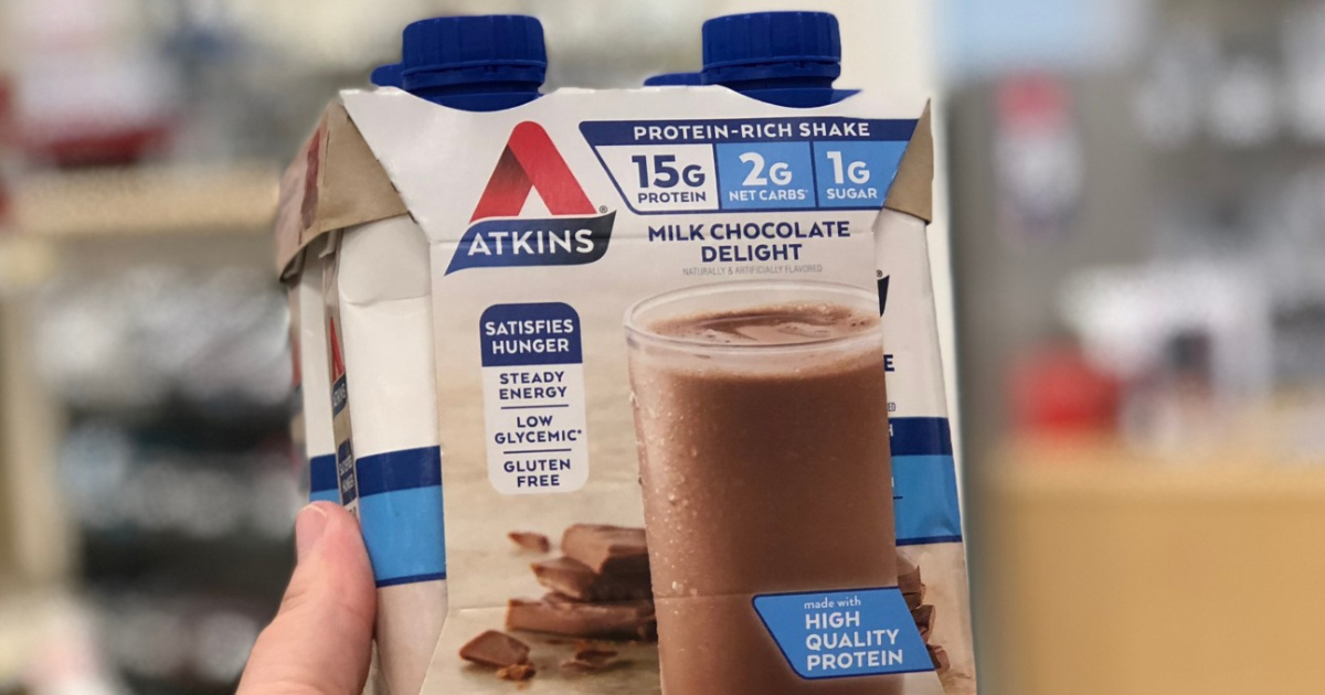 hand holding chocolate flavored protein shakes in store