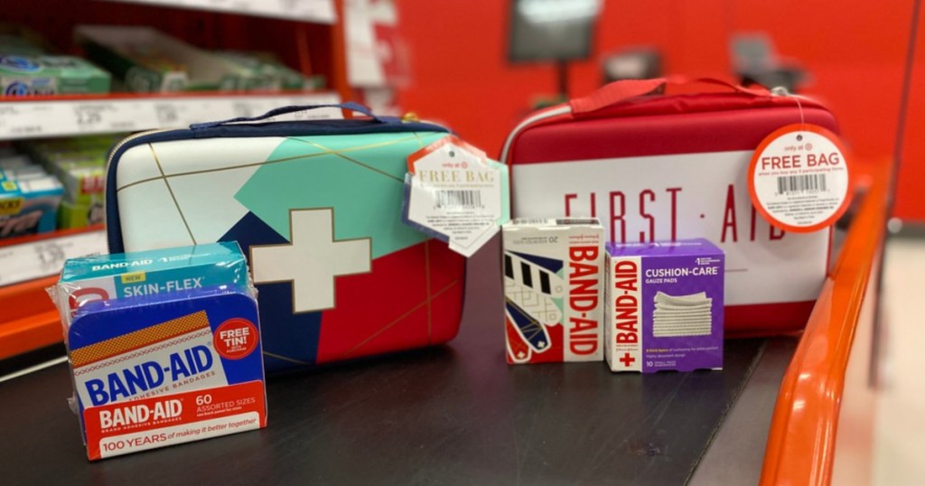 band-aids, gauze wraps, and two first aid kit bags on store conveyor belt