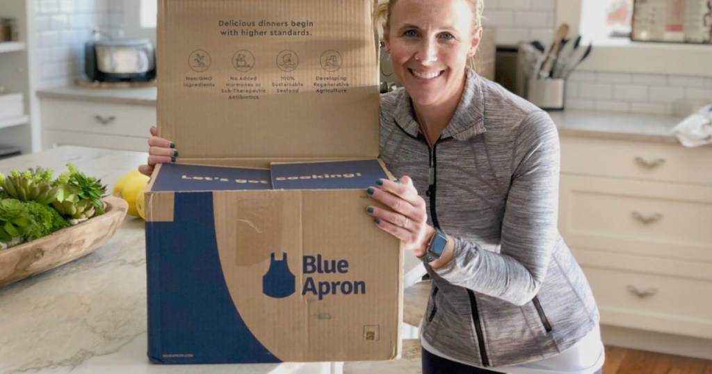 Woman standing next to Blue Apron meal box