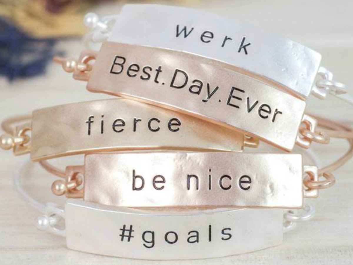 Stack of stamped bracelets with inspirational messages
