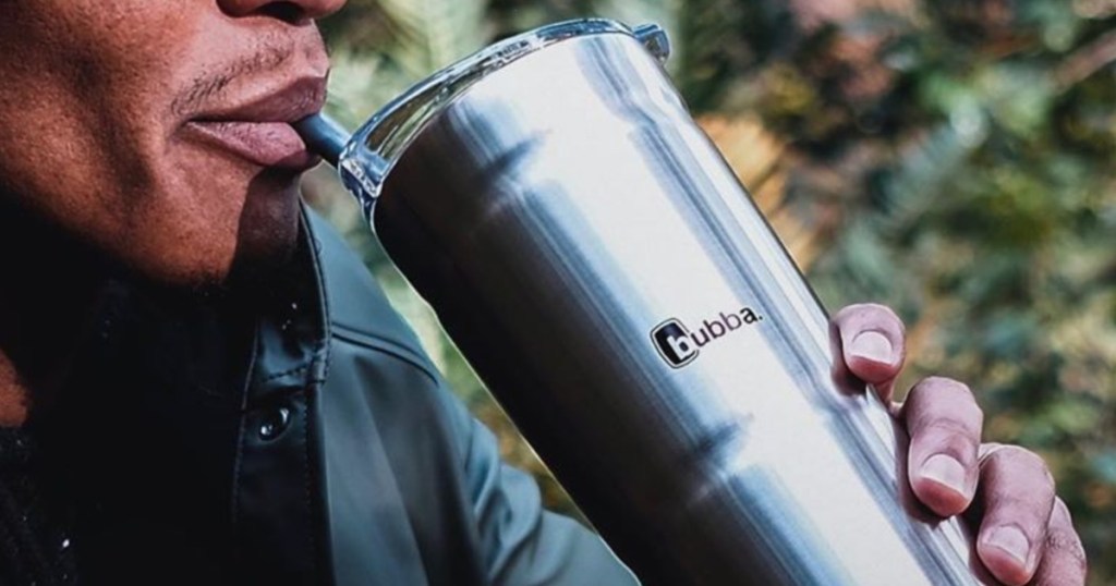 man drinking from stainless steel tumbler