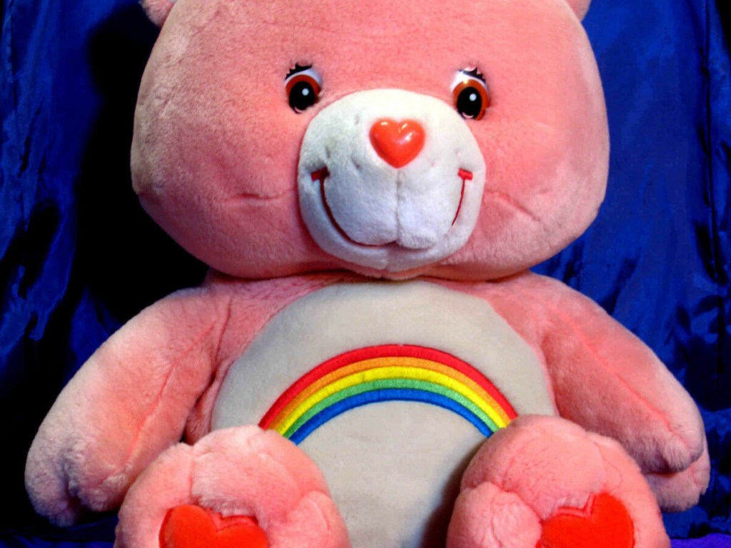 pink plush bear with rainbow on stomach
