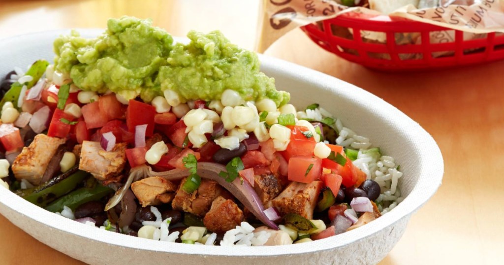 loaded chipotle burrito bowl with veggies and guac on top