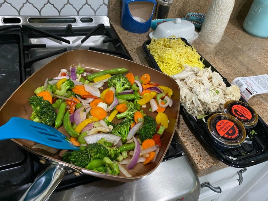 Person cooking a Yakisoba stir fry meal at home