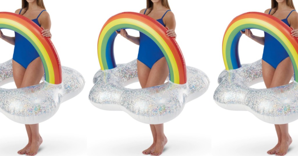 woman in blue one-piece bathing suit holding rainbow cloud pool float tube