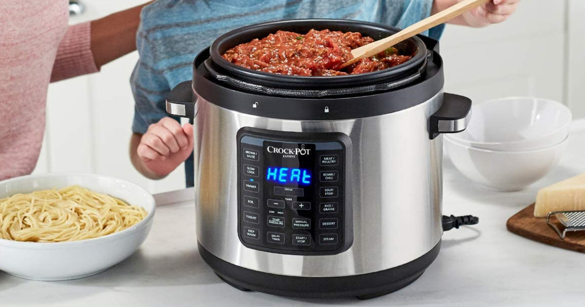 woman and child leaning over Crock Pot Express Multi Cooker stirring food