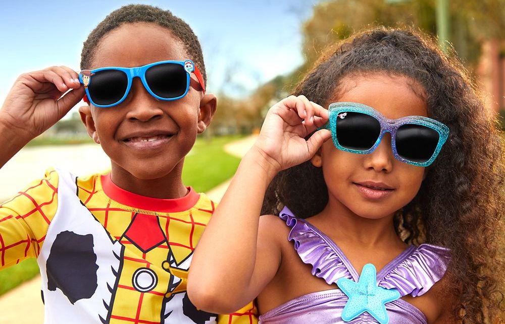 kids wearing and holding their sunglasses