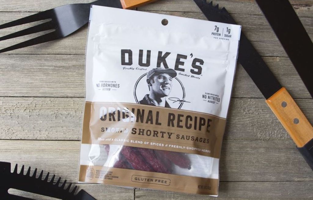 bag of Duke's Original Recipe Shorty Smoked Sausages on deck with grill utensils