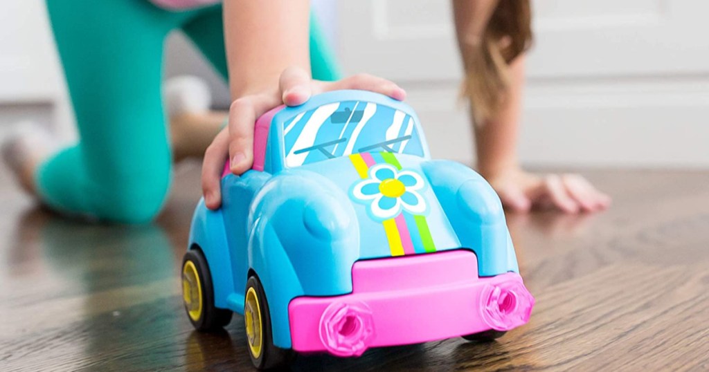 hand pushing blue flower toy car