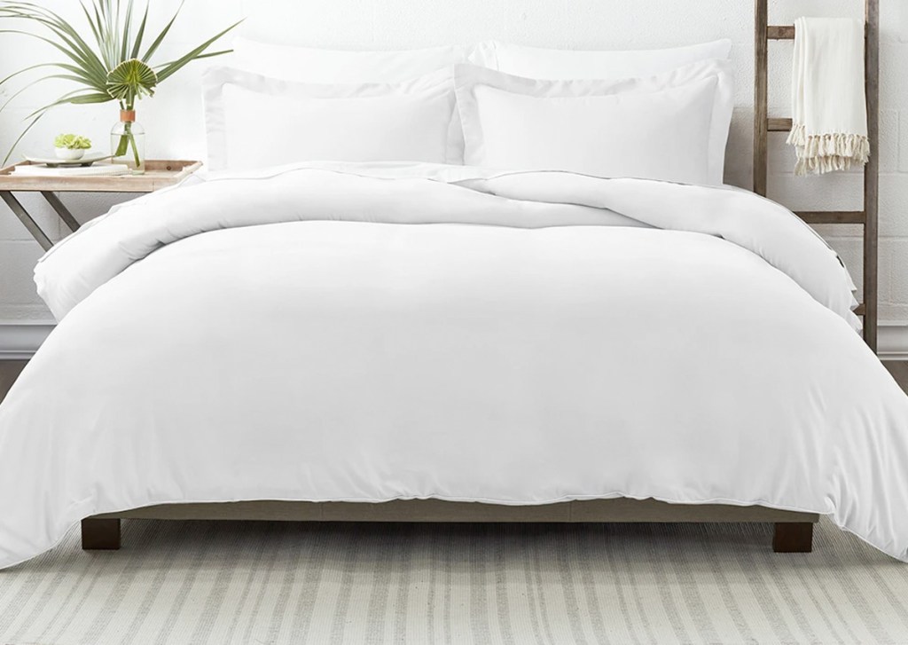 white duvet on bed with white sheets