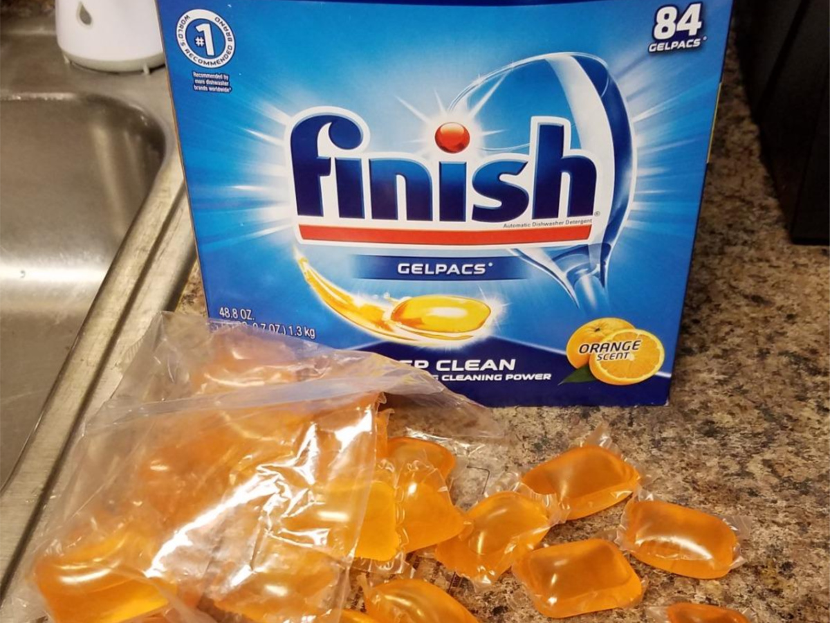 dishwasher detergent pacs box on kitchen counter with orange pacs in front