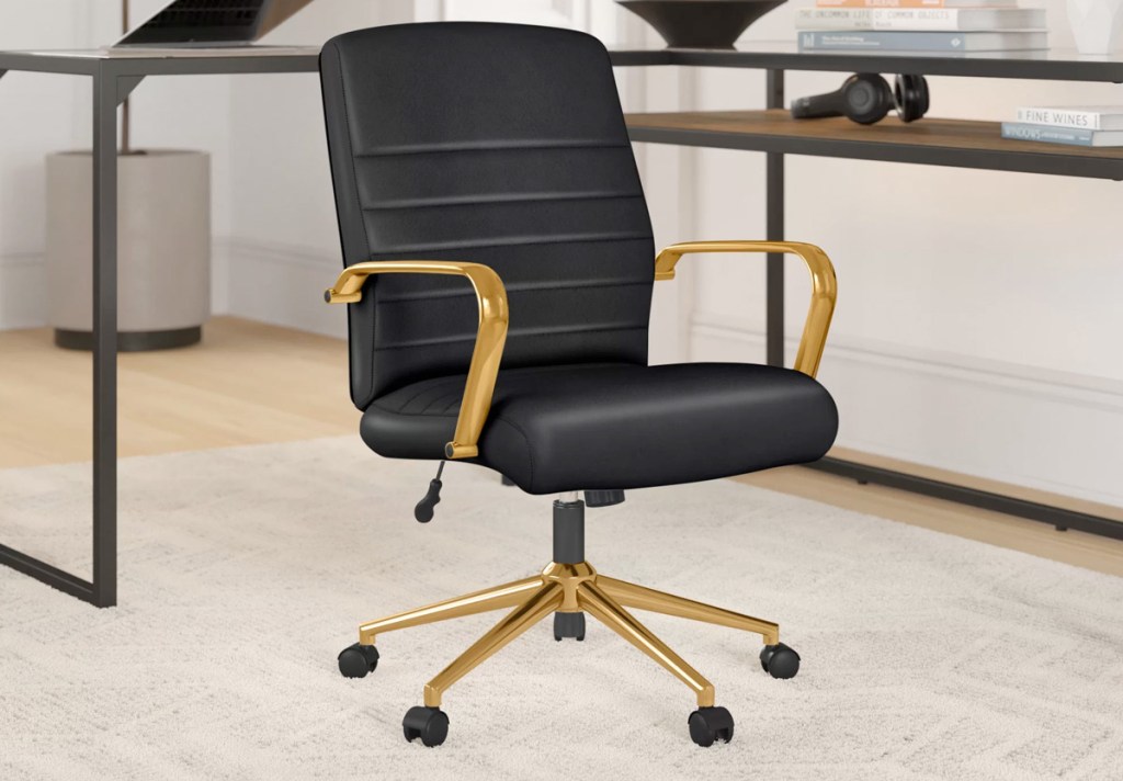 black leather office chair with gold arms and legs in home office
