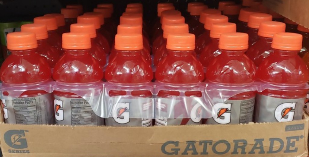 pack of red energy drink bottles in cardboard box on store shelf
