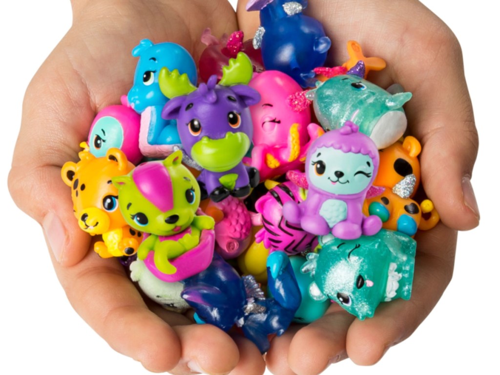 hands holding various animal toys