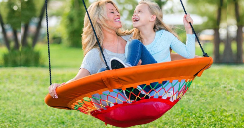 woman and daughter swinging on bungee swing