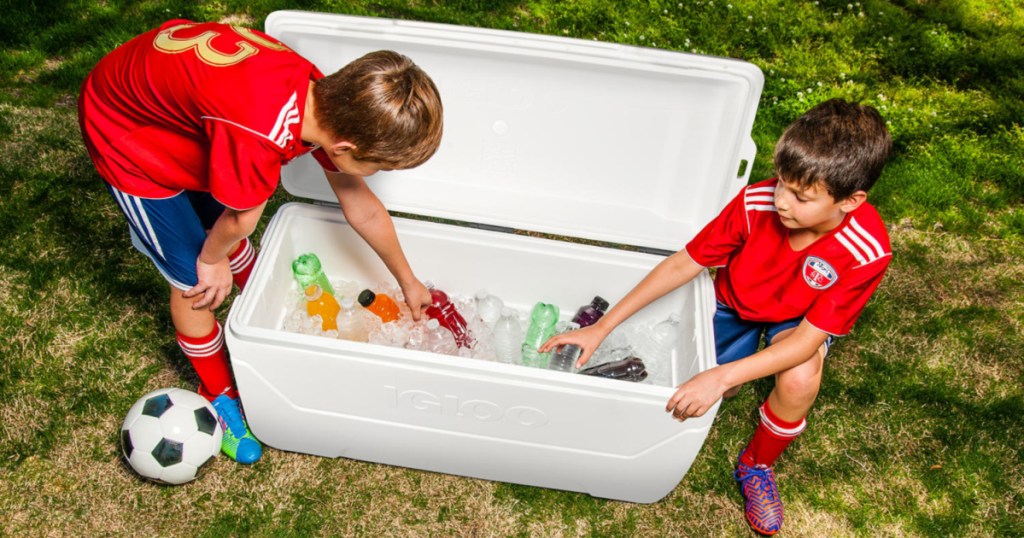 two young boys in soccer uniforms getting a drink out of Igloo 150-Qt. MaxCold Performance Cooler