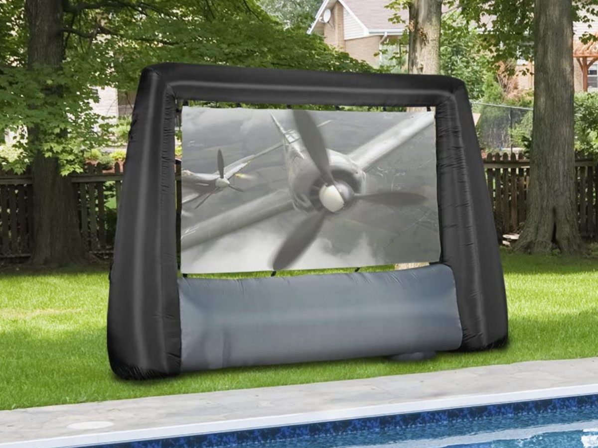 Giant Inflatable Movie Screen sitting on a lawn next to a pool outside