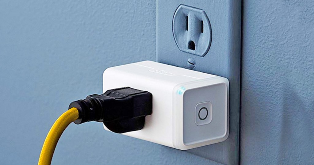 electrical plug plugged into smart plug outlet on wall