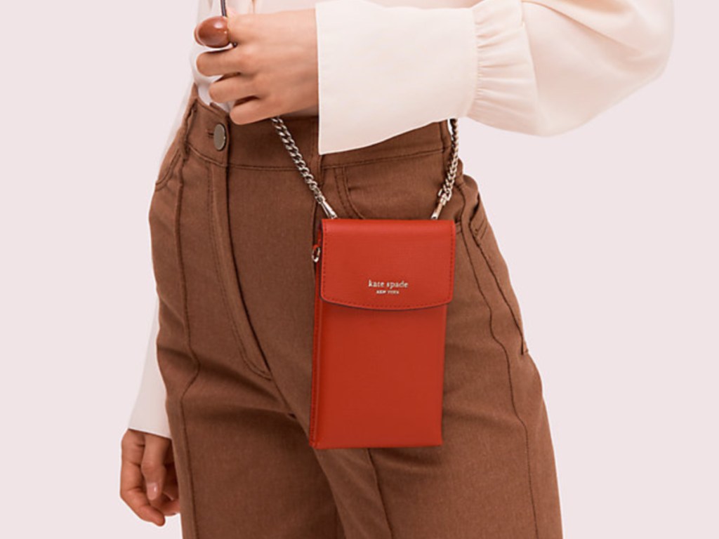 woman wearing small red crossbody bag