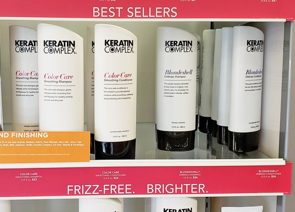 white bottles of Keratin Complex shampoo and conditioners on store display shelf