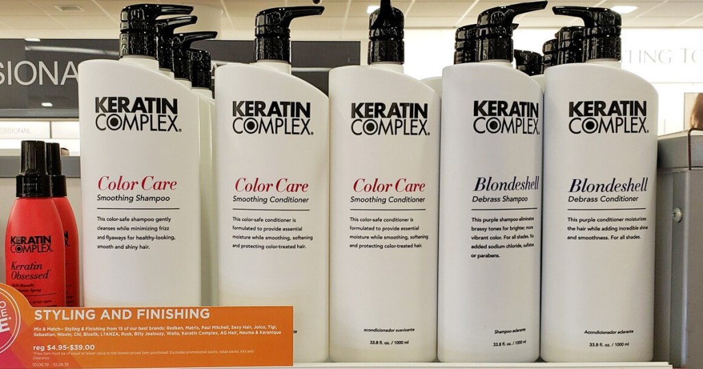 white bottles of Keratin Complex shampoo and conditioner on store display shelf