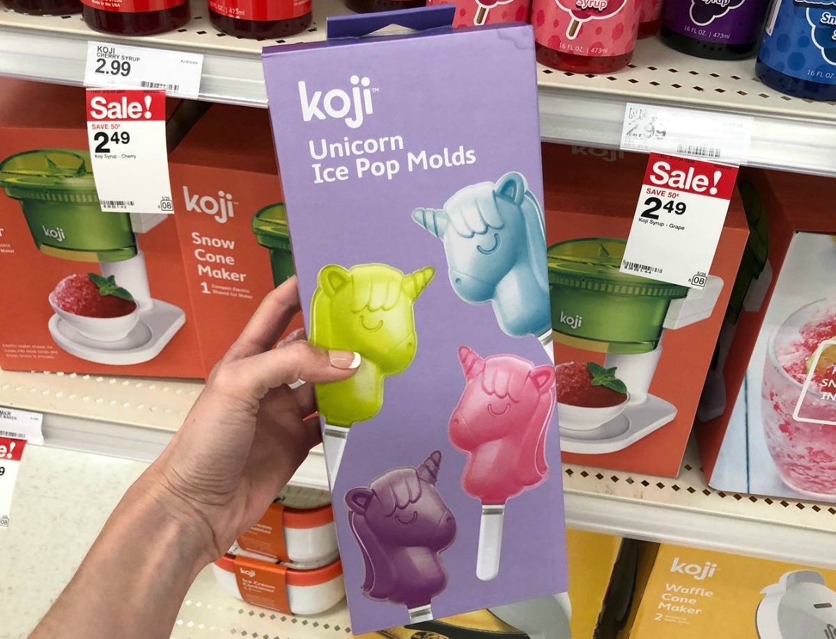 Unicorn themed popsicle mold in hand near in-store display