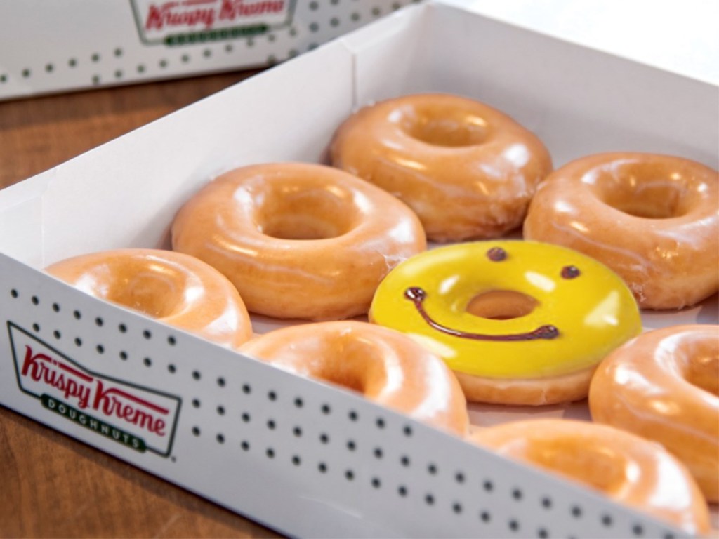 Krispy Kreme donuts with smiling donut in box