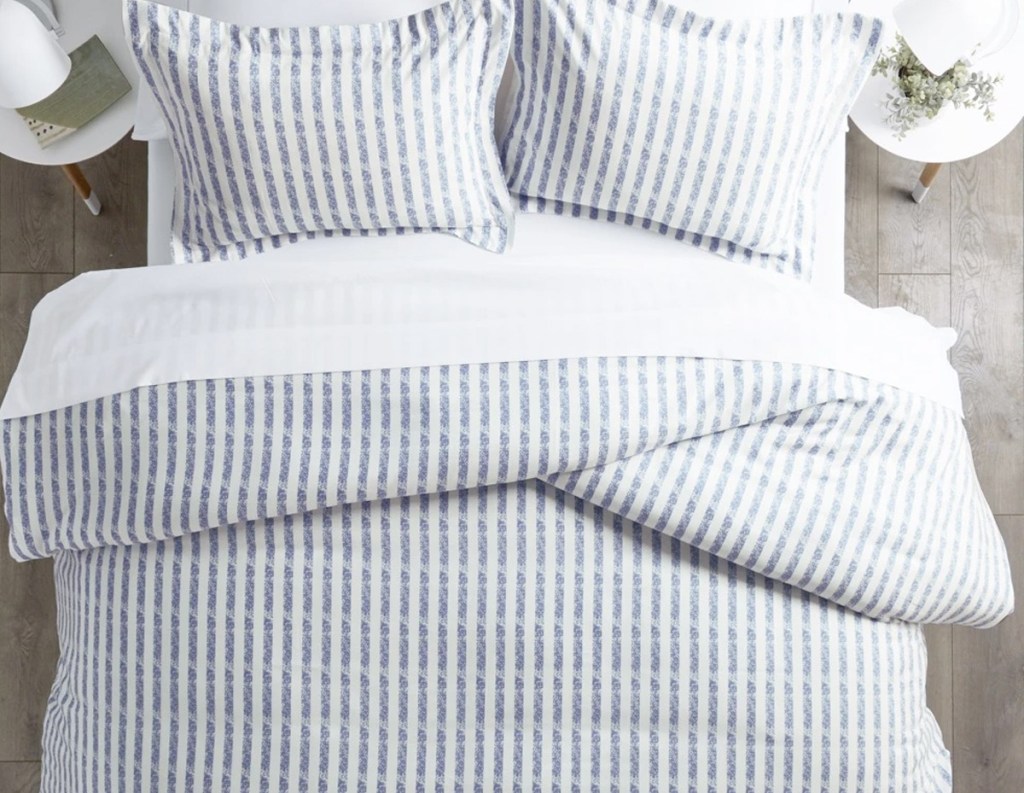 light blue and white striped duvet cover on bed with matching pillow shams
