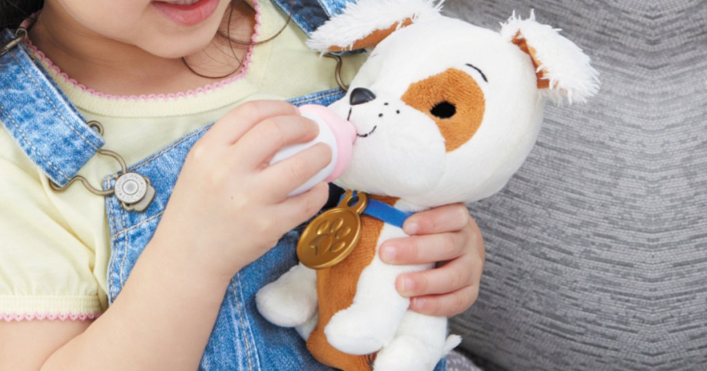 girl playing with puppy plush toy