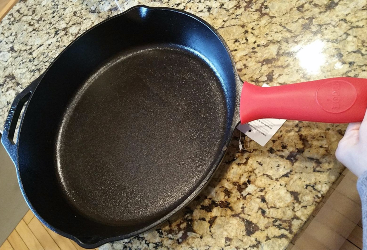 cast iron skillet with red handle cover on counter