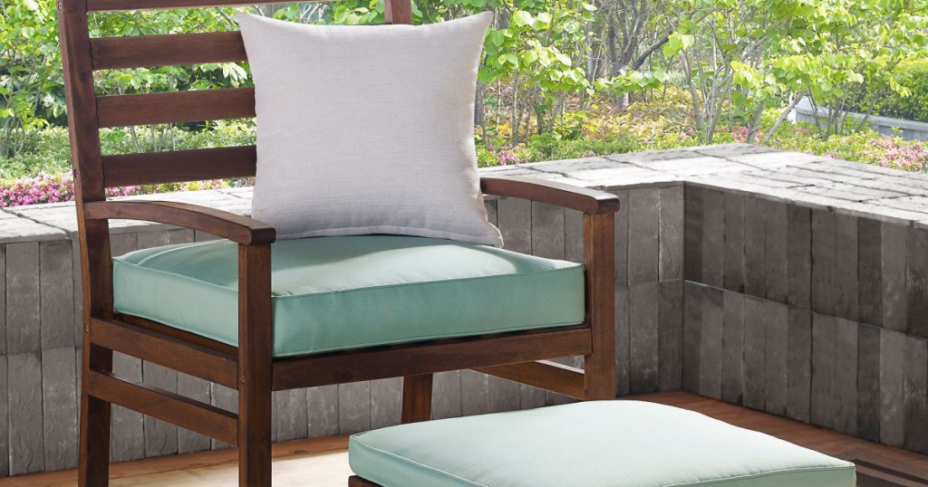 wood patio chair and ottoman with teal cushions on patio