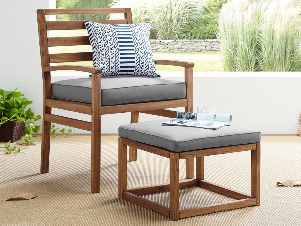 wood patio chair and ottoman with gray cushions on patio
