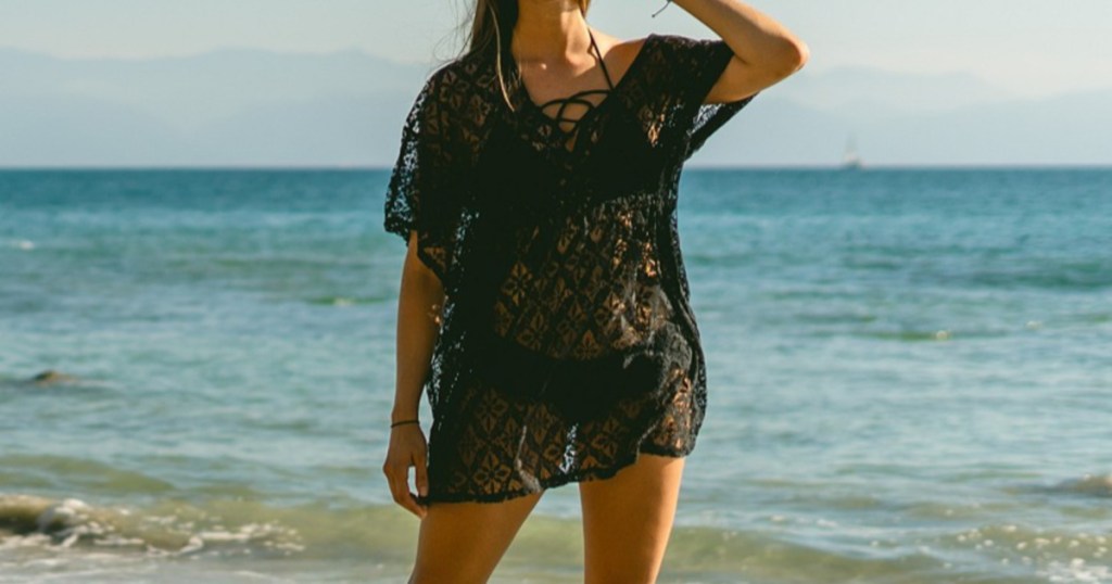 woman on beach in black crochet lace cover up